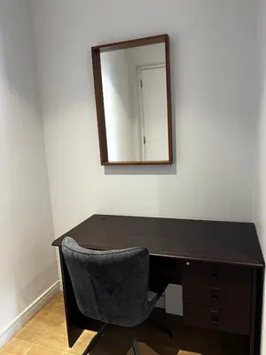 a desk with a chair and a mirror on a wall at Elegant Ellipse Waterfall Luxury with Gym, Spa & Dining in Midrand