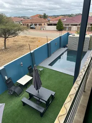 a patio with an umbrella and a table and chairs at Kbros Guesthouse in Polokwane