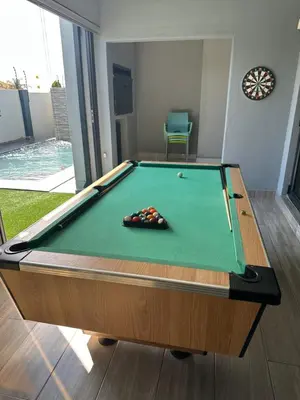 a pool table in a room with afits at Kbros Guesthouse in Polokwane