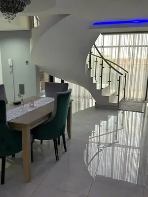 a dining room with a table and chairs and a staircase at Kbros Guesthouse in Polokwane