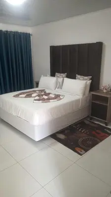 a large white bed in a room with at KLAAK hotel and Apartments