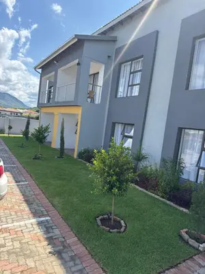 a white house with a tree in the yard at KLAAK hotel and Apartments