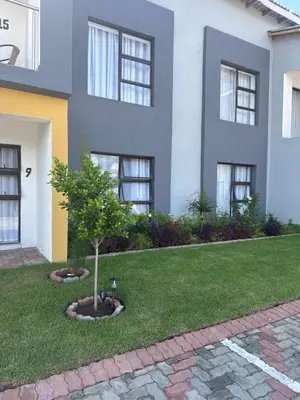a house with a tree in the front yard at KLAAK hotel and Apartments