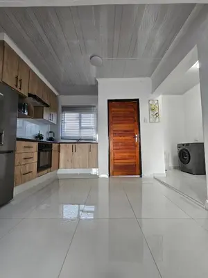 an empty kitchen with a wooden door in a room at KLAAK hotel and Apartments