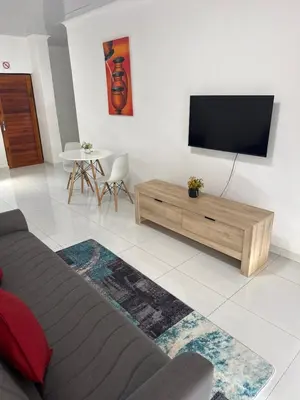 a living room with a flat screen tv on a wall at KLAAK hotel and Apartments