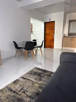 a living room with a couch and a table and chairs at KLAAK hotel and Apartments