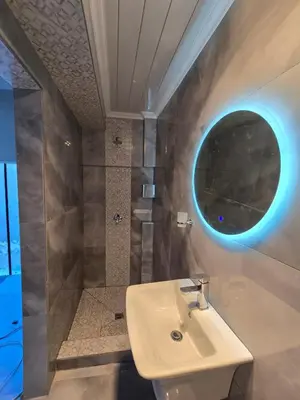 a bathroom with a sink and a shower and a mirror at Cozy Cove Midrand in Midrand