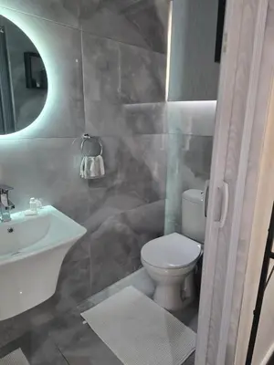 a bathroom with a toilet and a sink at Cozy Cove Midrand in Midrand