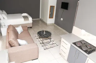 a living room with a couch and a bed at Grace View Guest House in Chartwell