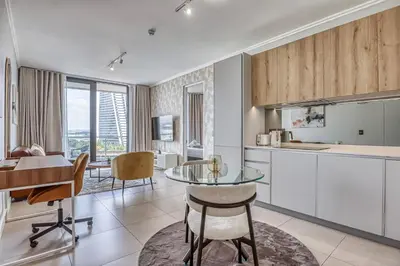 a kitchen and dining room with a glass table at Nova Luxe Midrand Waterfall Ellipse Galileo in Midrand