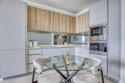 a kitchen with a glass table and two chairs at Nova Luxe Midrand Waterfall Ellipse Galileo in Midrand