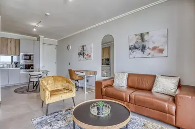 a living room with a couch and a table at Nova Luxe Midrand Waterfall Ellipse Galileo in Midrand