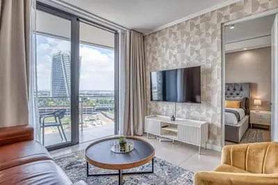 a hotel room with a king bed and a large window at Nova Luxe Midrand Waterfall Ellipse Galileo in Midrand