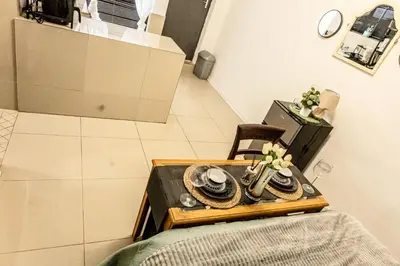 a table with plates on it in a room at Thorne's crip in Pretoria