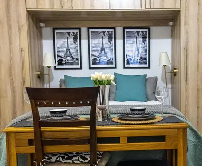 a dining room with a table and a couch at Thorne's crip in Pretoria