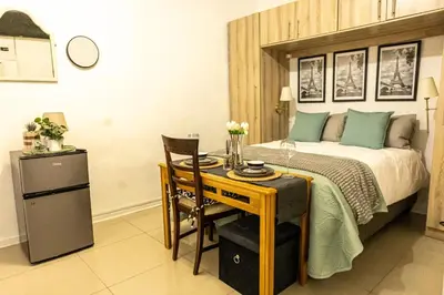 a bedroom with a bed and a table and a desk at Thorne's crip in Pretoria