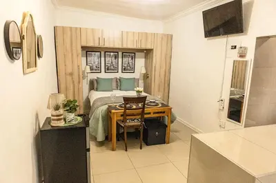a bedroom with a bed and a table with a table at Thorne's crip in Pretoria