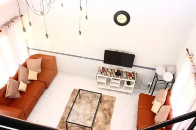 a living room with a couch and a tv at Unit 35 Pendleberry grove holidays in Bela-Bela