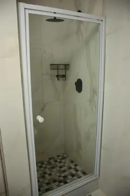 a shower with a glass door in a bathroom at Unit 35 Pendleberry grove holidays in Bela-Bela