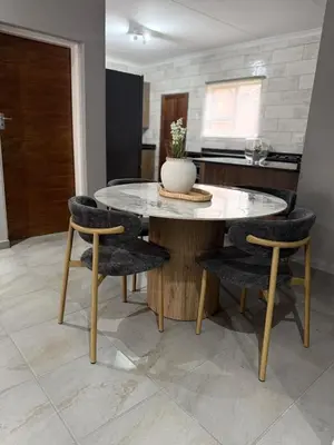 a dining room with a table and chairs at Cozzy home in Polokwane