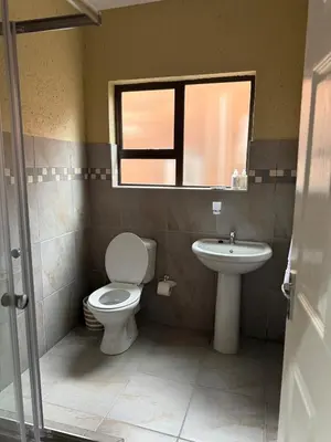 a bathroom with a toilet and a sink at Cozzy home in Polokwane