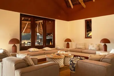 a living room with couches and a large window at Zebras Crossing in Modimolle