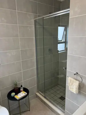 a shower with a glass door in a bathroom at Apartment at The Blyde in Pretoria