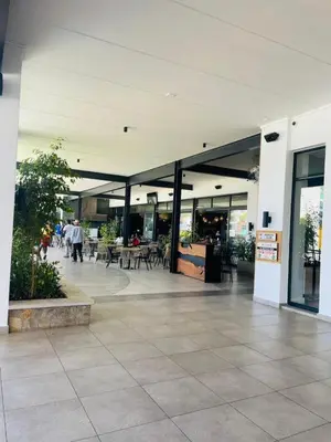 a lobby of a building with people walking in it at Apartment at The Blyde in Pretoria