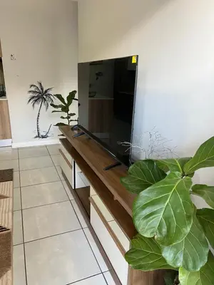 a living room with a flat screen tv on a wall at Apartment at The Blyde in Pretoria