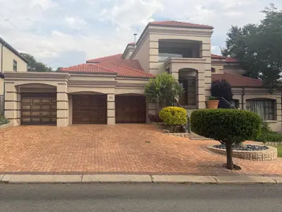 a house with two garage doors on a brick driveway at The Country Hole Haven in Centurion