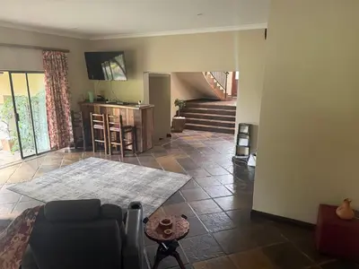 a living room with a couch and a table at The Country Hole Haven in Centurion