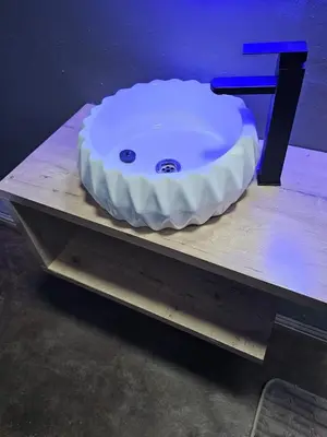a white sink sitting on top of a table at Cuse Boutique Lodge and Conference in Polokwane