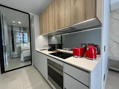 a kitchen with red appliances on a counter at The S-teemed at Ellipse in Midrand