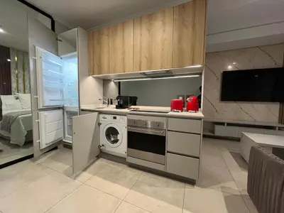 a kitchen with a washing machine and a washer at The S-teemed at Ellipse in Midrand