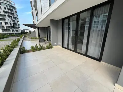 an empty patio in a building with glass doors at The S-teemed at Ellipse in Midrand