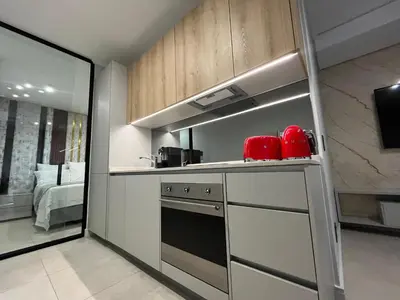 a kitchen with a sink and a stove top oven at The S-teemed at Ellipse in Midrand