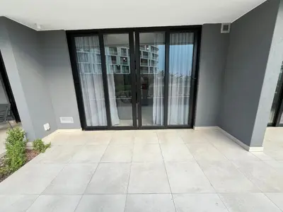 an empty room with glass doors in a building at The S-teemed at Ellipse in Midrand