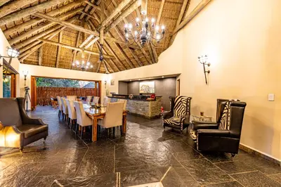 a dining room with a table and chairs at Kusudalweni Safari Lodge and Spa in Guernsey Nature Reserve