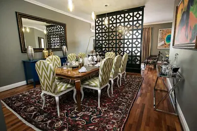 a dining room with a wooden table and chairs at Mavuta Boutique Apartments in Polokwane