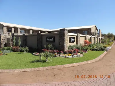 a building with a garden in front of it at Mavuta Boutique Apartments in Polokwane
