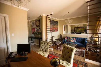 a living room with a desk with a computer on it at Mavuta Boutique Apartments in Polokwane
