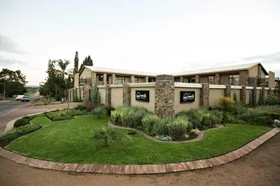 a building with a garden in front of it at Mavuta Boutique Apartments in Polokwane