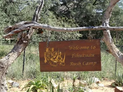 a sign for a bush camp hanging from a tree at Tshukudu Bush Camp in Hoedspruit