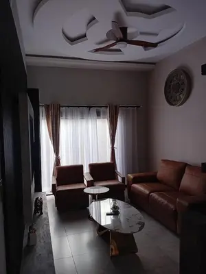 a living room with a couch and a table at Big Mo Bev and Grill in Middelburg