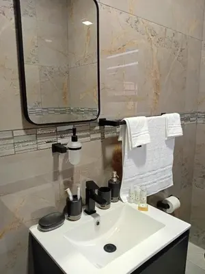 a bathroom with a white sink and a mirror at Big Mo Bev and Grill in Middelburg
