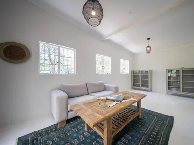 a living room with a couch and a table at Memory Makers Bush Lodge in Hoedspruit