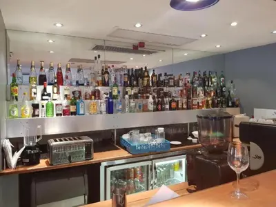 a bar with a lot of bottles of alcohol at Court Classique Suite Hotel in Pretoria