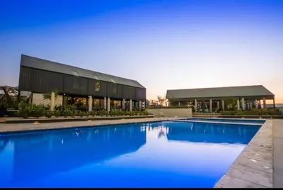 a large swimming pool in front of a building at The Legacy Loft in Kyalami