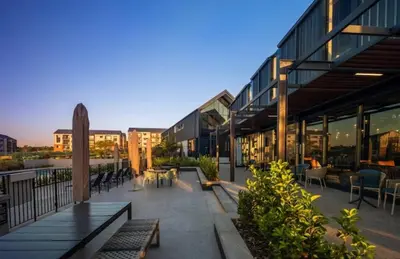 a building with benches and tables and chairs at The Legacy Loft in Kyalami