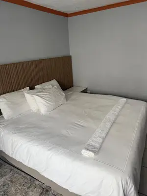 a white bed with a long white blanket on it at Petron home in Kempton Park